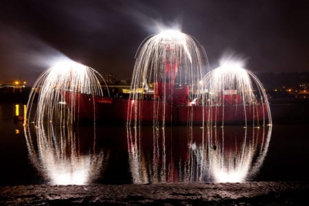 Image of ship in water with long exposure light strands